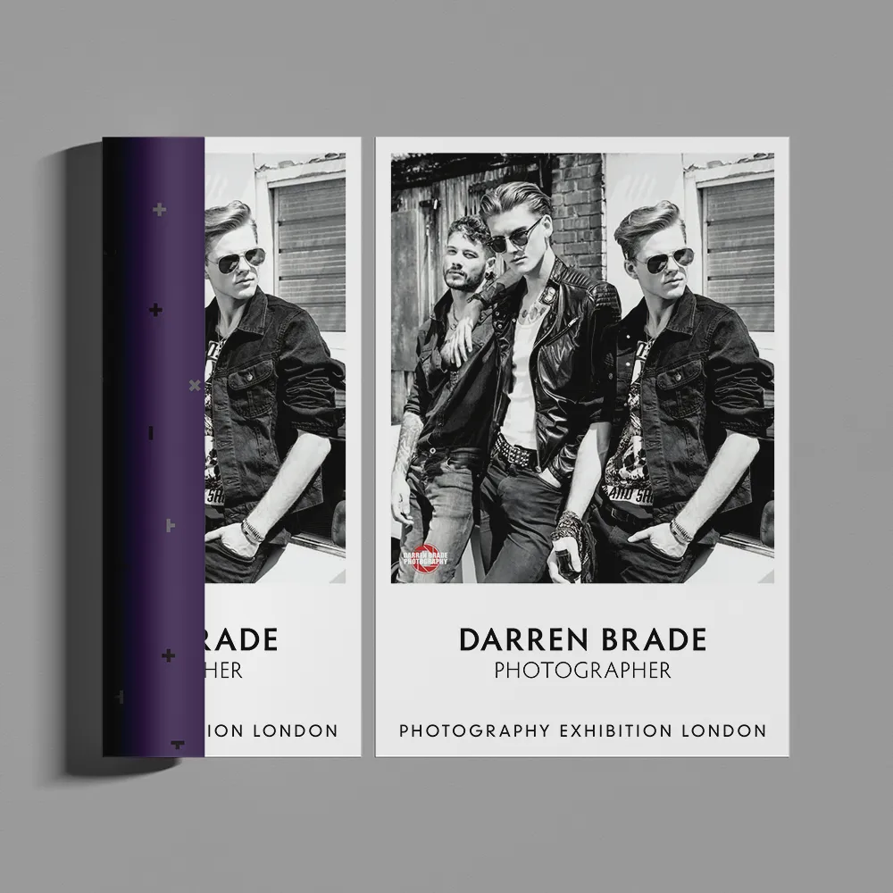 Two black and white photographs depict three men wearing sunglasses and leather jackets, leaning casually against a wall. The text below reads "Darren Brade - Photographer," with additional text indicating a photography exhibition in London. This striking image doubles as an exhibition poster.