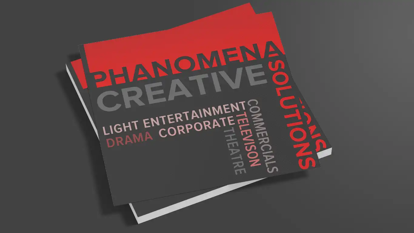 Phanomena-Exhibition-Merchandise-Design-Cards A stack of brochures with a red and black color scheme. The top brochure reads "Phanomena Creative Solutions" in bold, listing words like "Light Entertainment," "Drama," "Corporate," "Commercials," "Television," and "Theatre." Expertise in Merchandise Design is also prominently highlighted.
